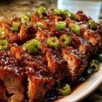 Close-up of sliced Jalapeno Glazed Pork Tenderloin, topped with fresh jalapenos.