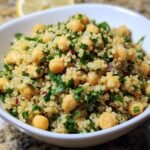 A bowl of Lemon Herb Quinoa Chickpeas, a healthy and flavorful dish with fresh herbs.