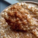 Close-up of creamy Quinoa Pudding sprinkled with cinnamon, a SiLLibake recipe.