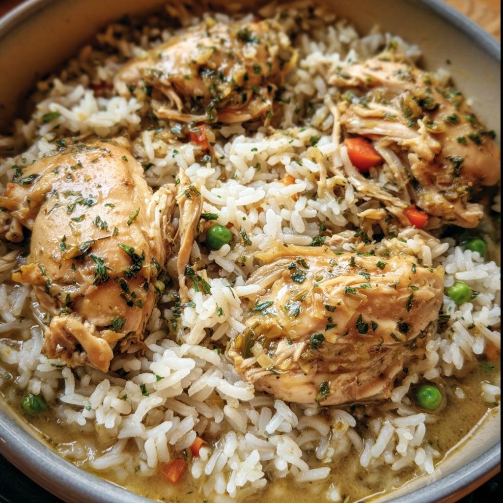 Close-up of Slow Cooker Chicken and Rice in a bowl, garnished with herbs and vegetables.