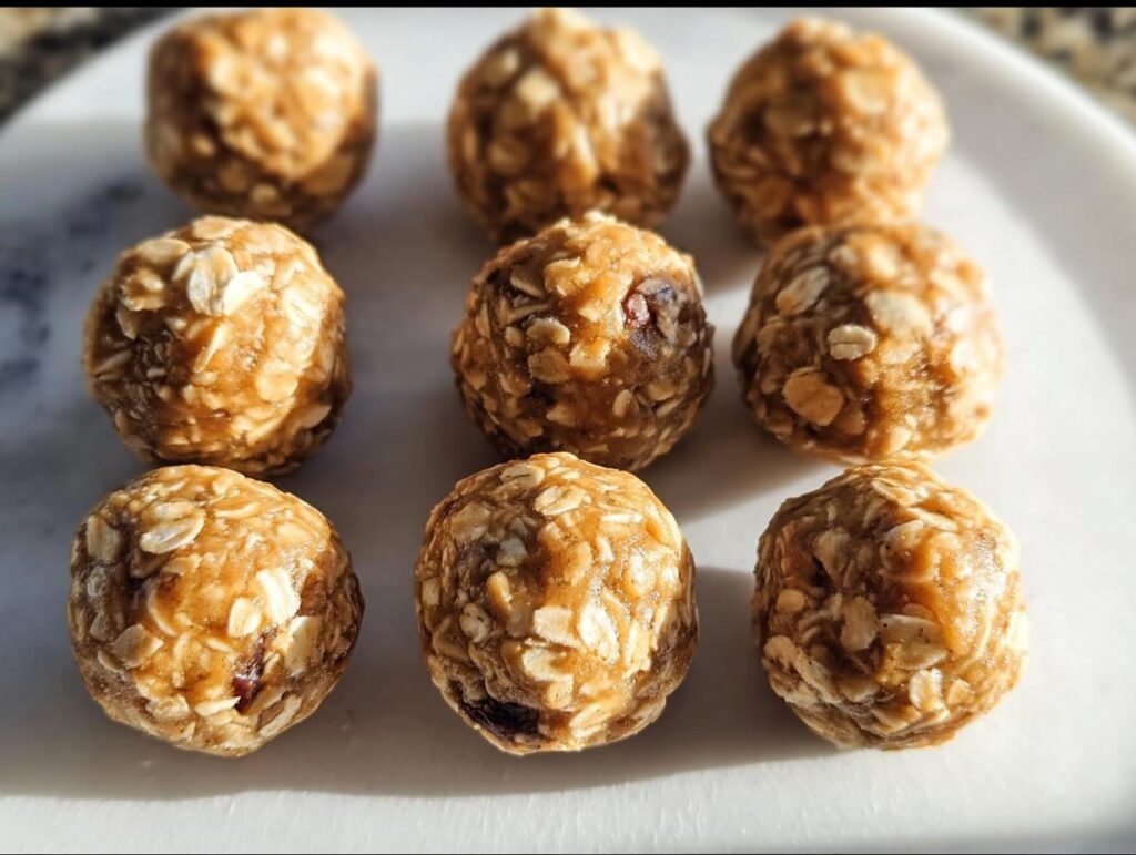 Nine butterscotch protein balls arranged on a white plate, showcasing their texture and ingredients.