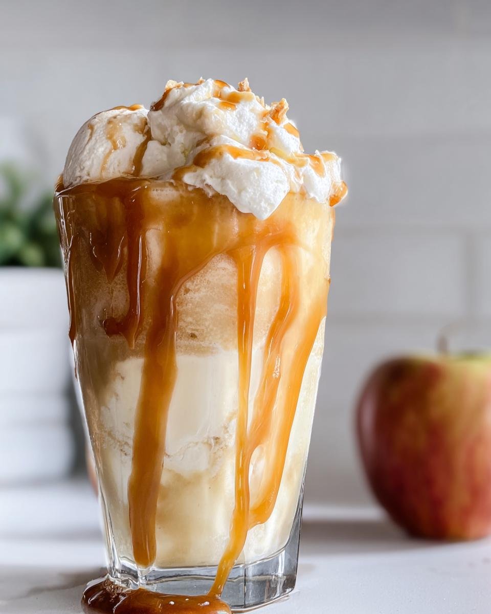 A decadent Caramel Apple Cider Float with ice cream, whipped cream, and caramel drizzle.