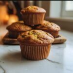 A stack of delicious Cottage Cheese Pumpkin Muffins on a wooden tray, ready to eat.