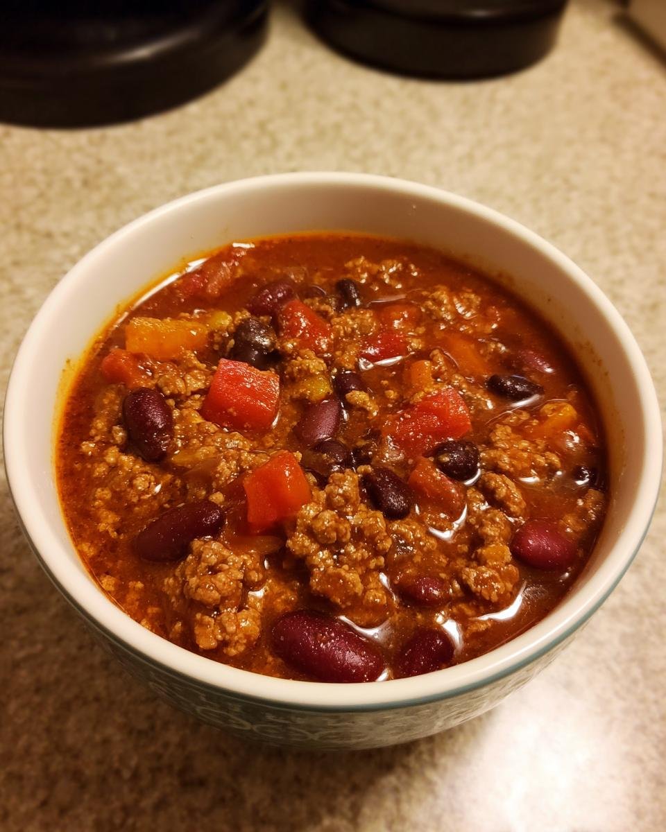 A bowl of hearty Ground Turkey Chili (Stovetop) with beans, tomatoes, and ground turkey.