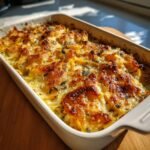 Golden brown Sage Butternut Squash Gratin in a white baking dish, ready to serve.
