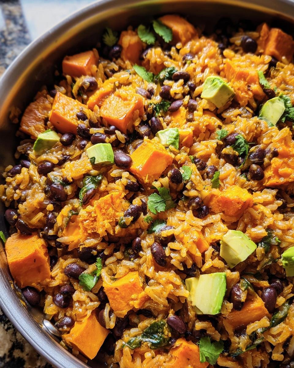 A vibrant Sweet Potato, Black Bean and Rice Skillet with avocado and cilantro.