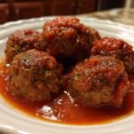 A plate of juicy Turkey Meatballs In Marinara sauce, garnished with herbs, ready to be served.