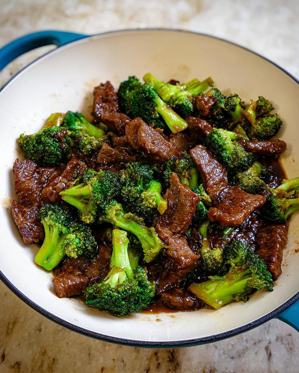 Close-up of tender slices of beef and bright green broccoli florets coated in a savory sauce for Beef and Broccoli Stir Fry.