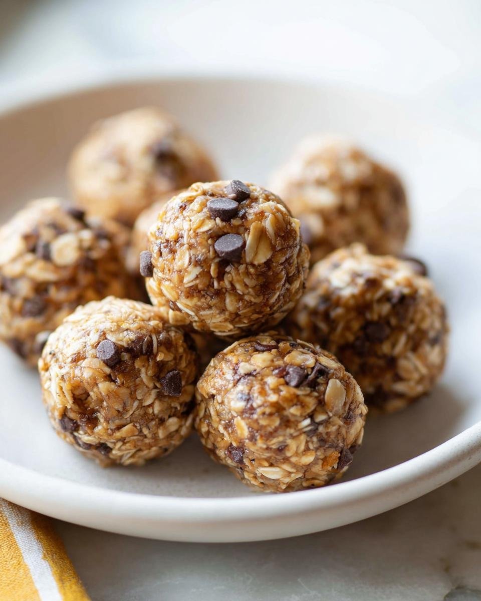 Close-up of several oatmeal energy bites with mini chocolate chips, perfect for low-calorie snacks for January.